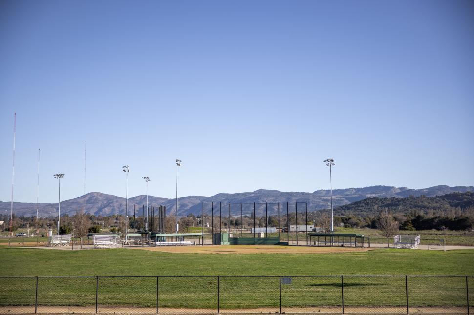 Free Image of Open baseball field with mountain view 