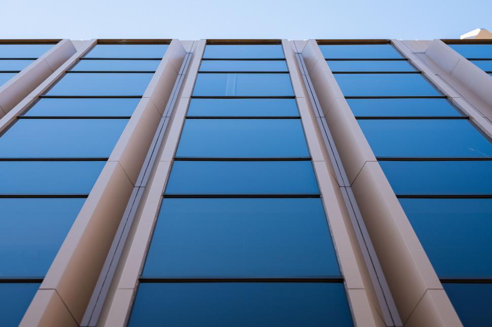 Free Image of Modern blue glass building facade looking up 