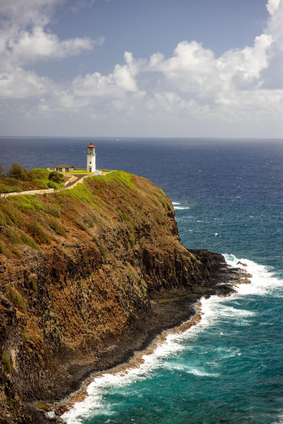 Free Image of Lighthouse on cliff overlooking the ocean 