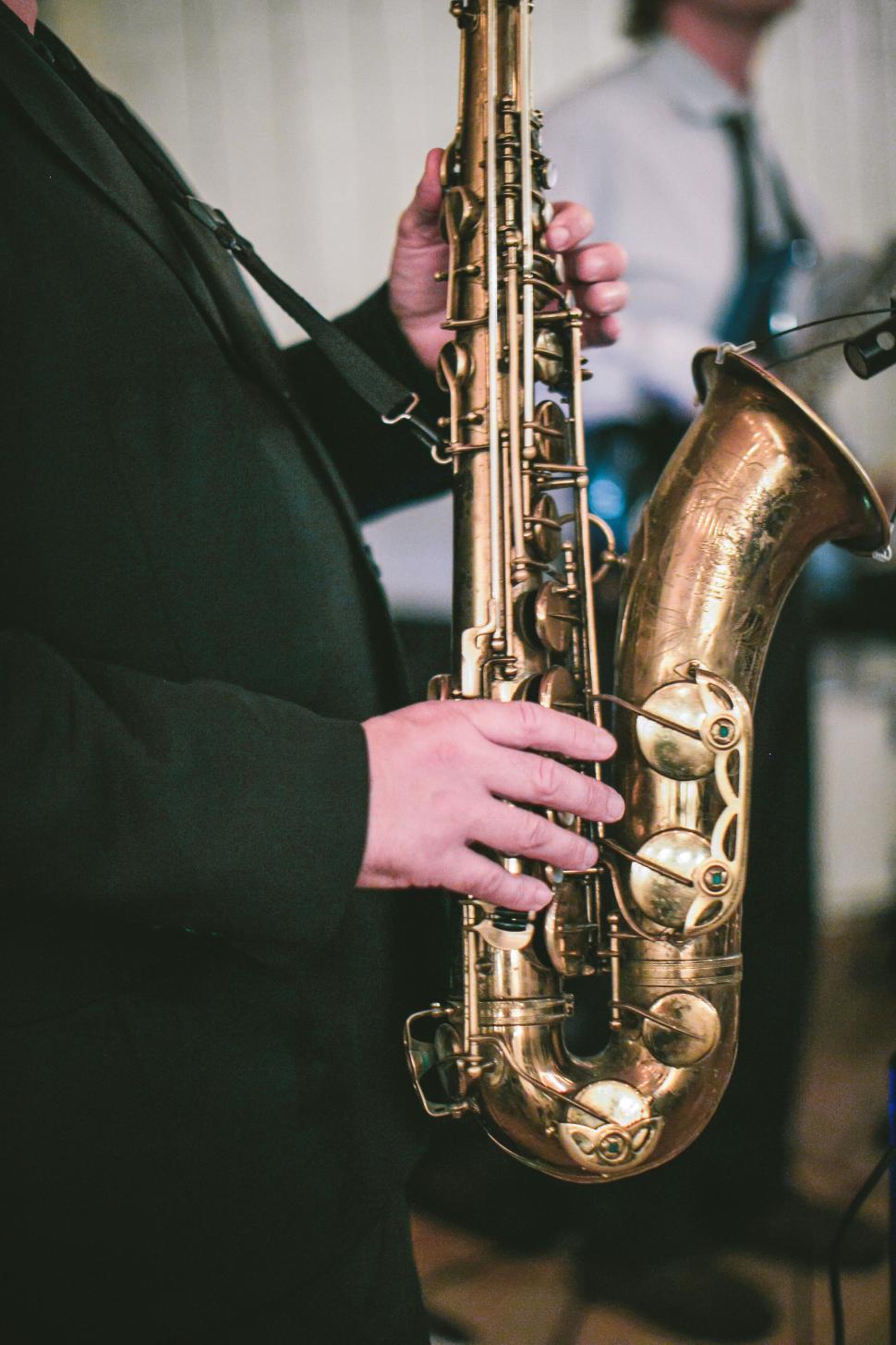 Free Image of Musician playing a saxophone in a live band 