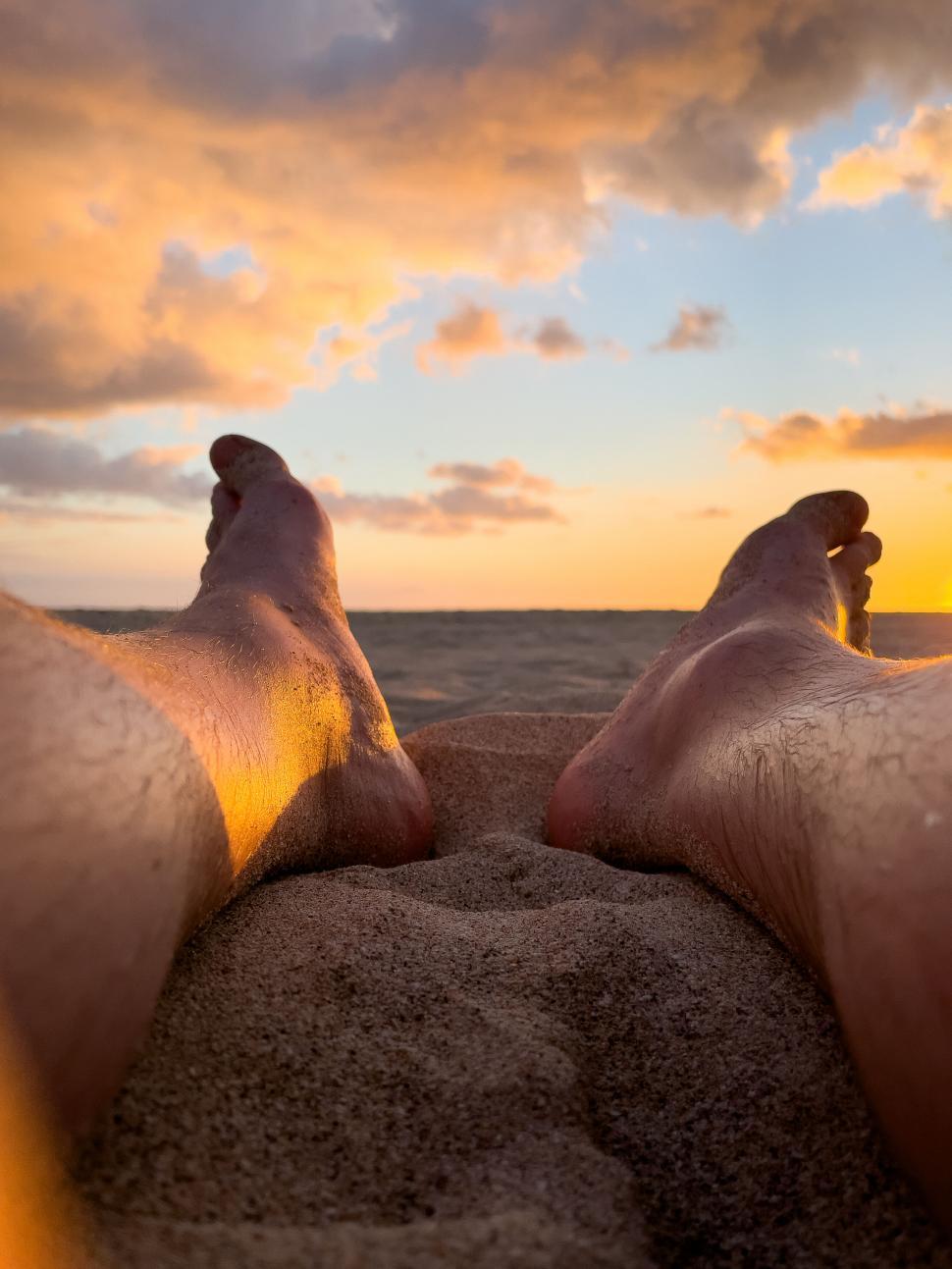 Free Image of Relaxing view of feet against beach sunset 
