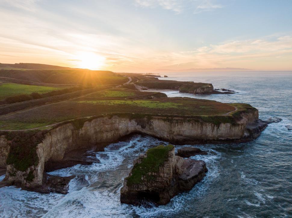 Free Image of Aerial view of a coastal landscape at sunset 