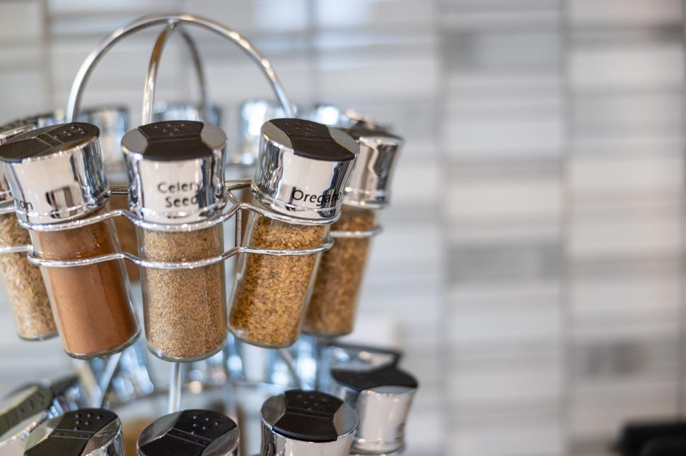 Free Image of Spice rack with labeled seasoning jars 