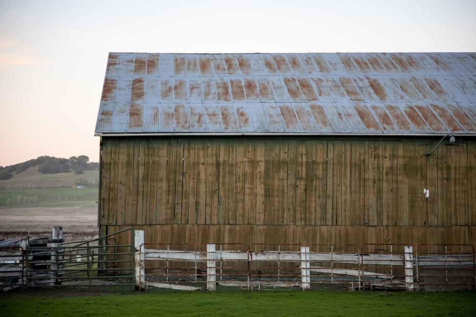 Free Image of Rustic barn in golden hour farmland 