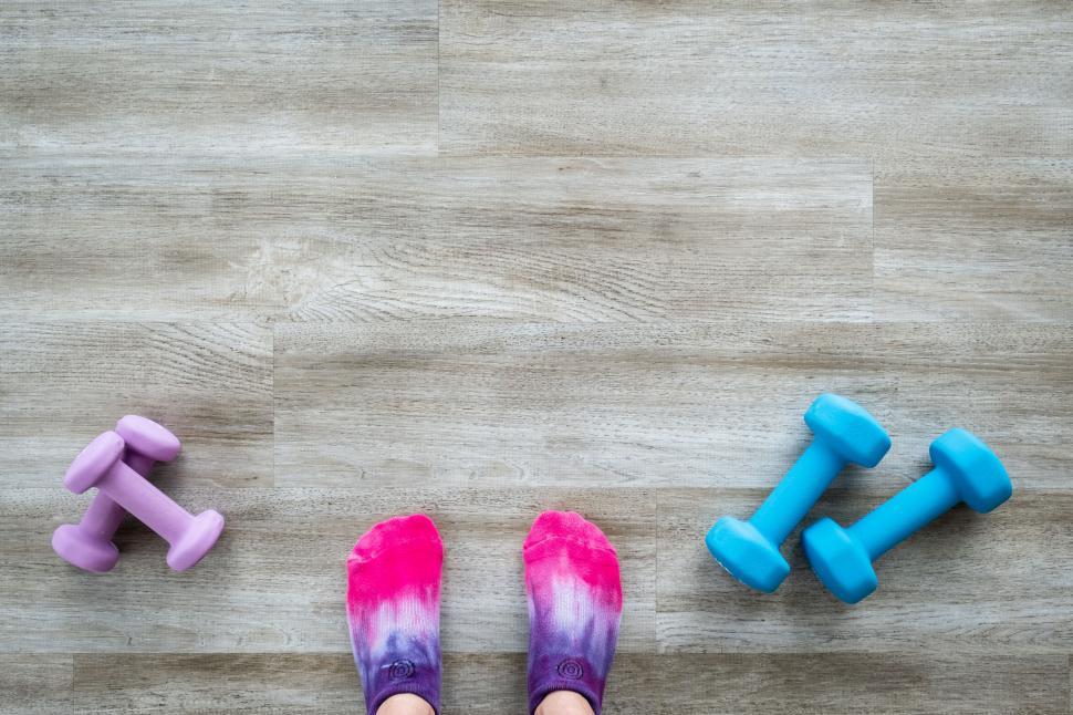 Free Image of Feet and dumbbells on wooden floor 