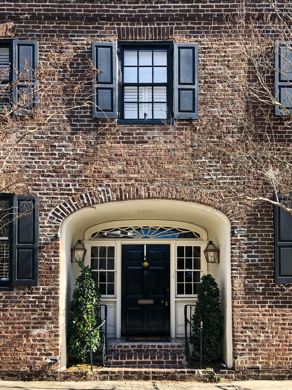 Free Image of Classic brick house front with arched entryway 