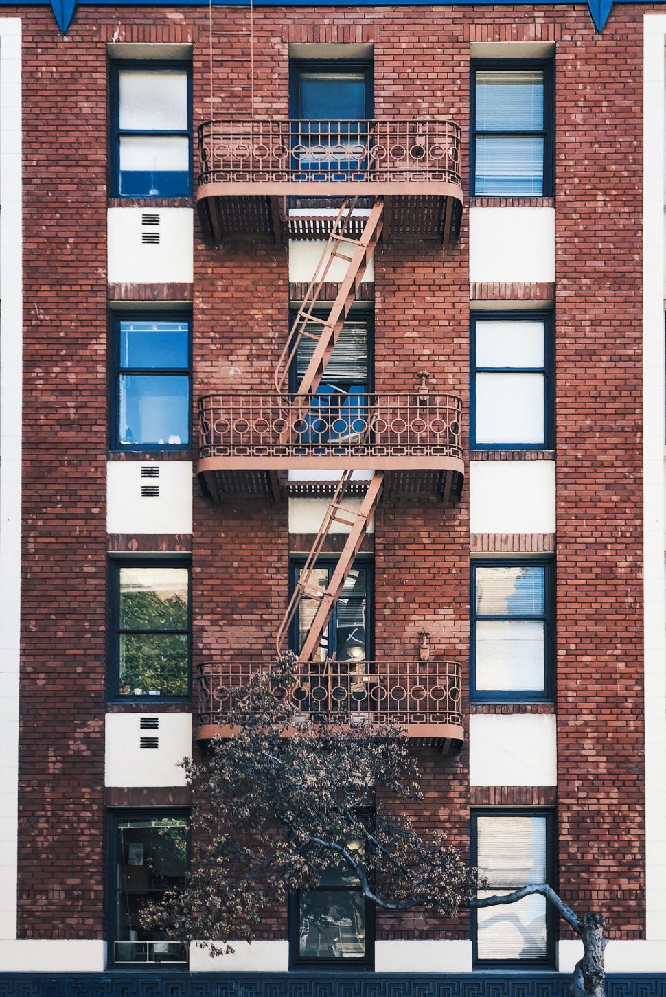 Free Image of Classic brick building with fire escapes 