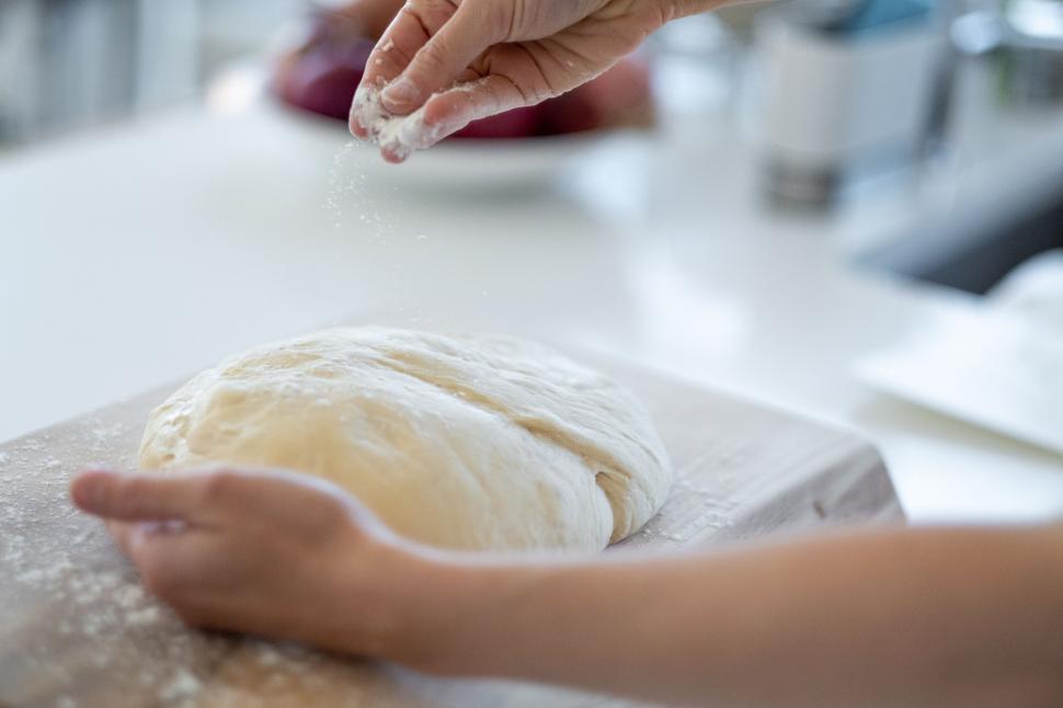 Free Image of Kneading dough on a flour-dusted board 