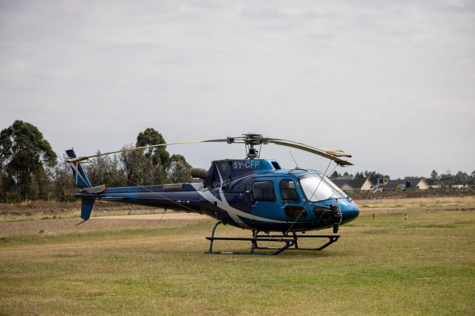 Free Image of Blue helicopter parked on grass field 