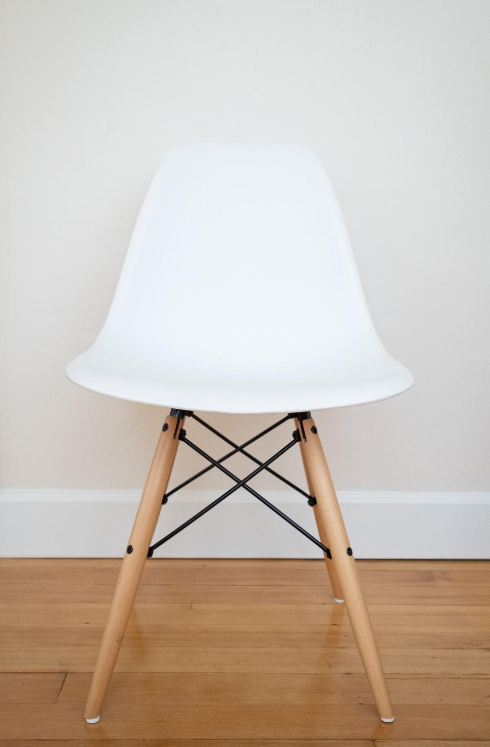 Free Image of Modern white chair against beige wall 