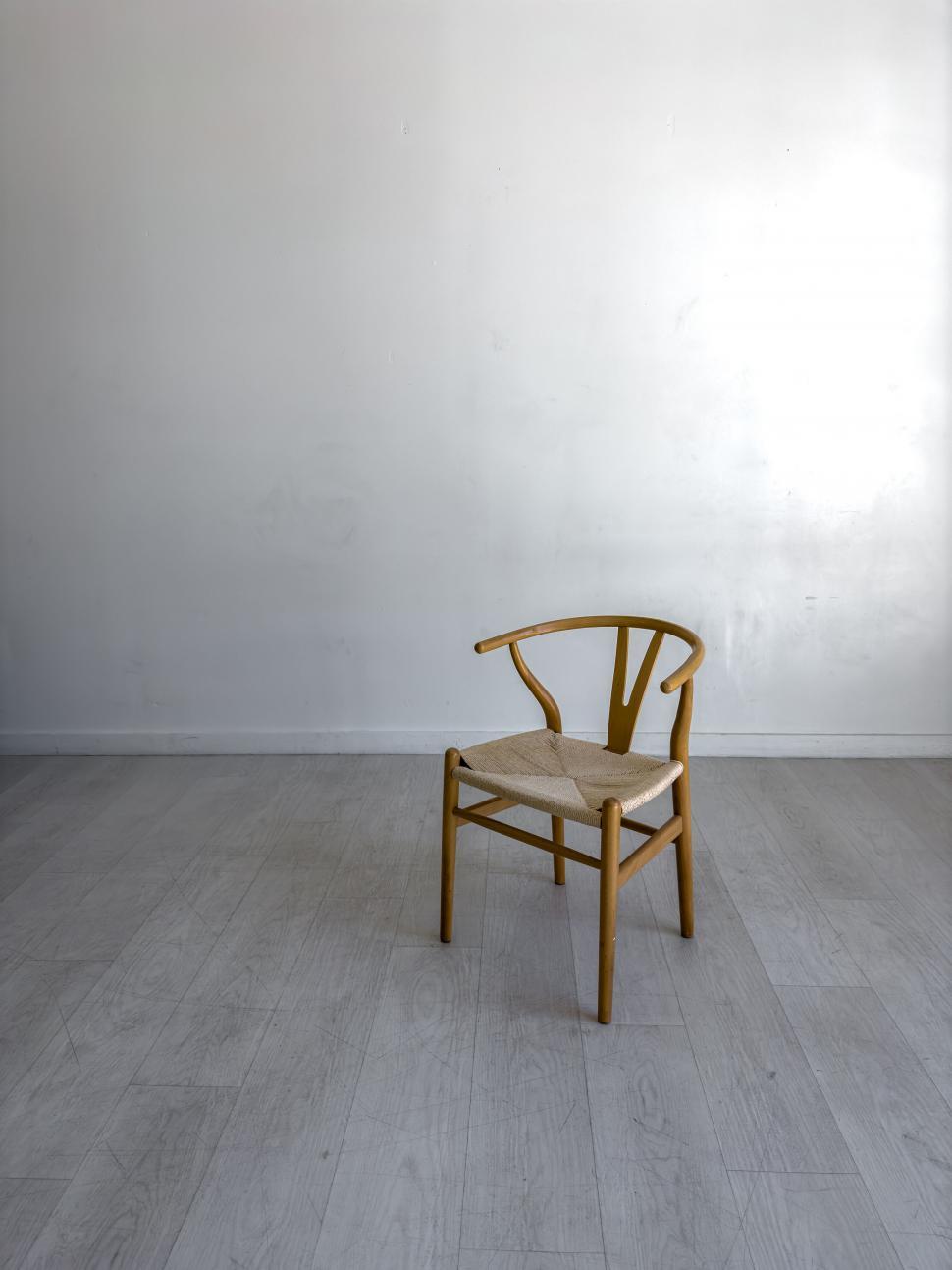 Free Image of Minimalistic wooden chair in empty room 