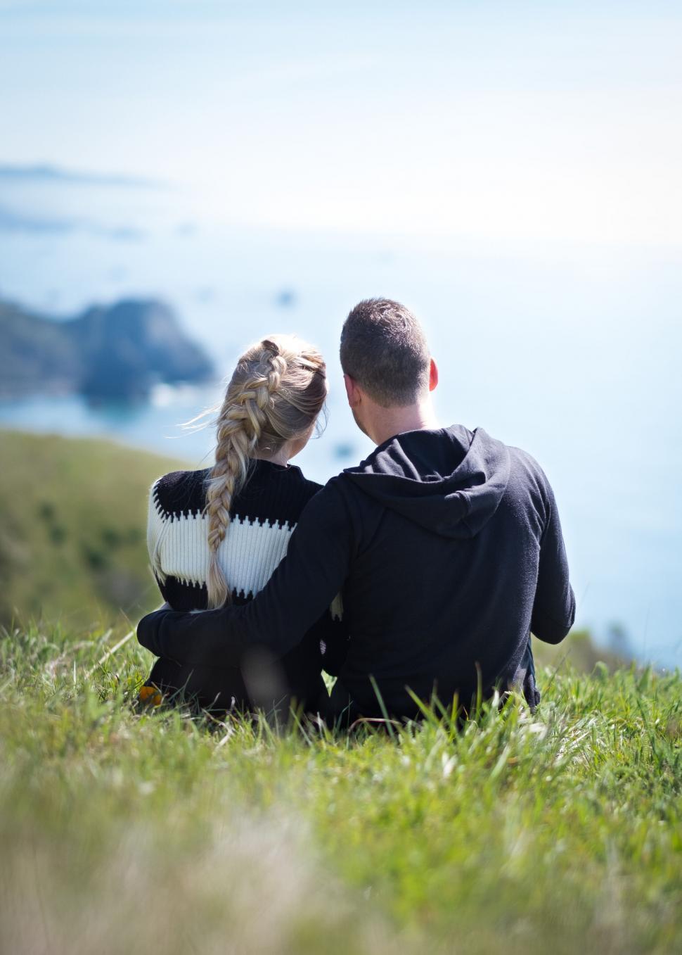 Free Image of Couple embracing while looking at the sea 