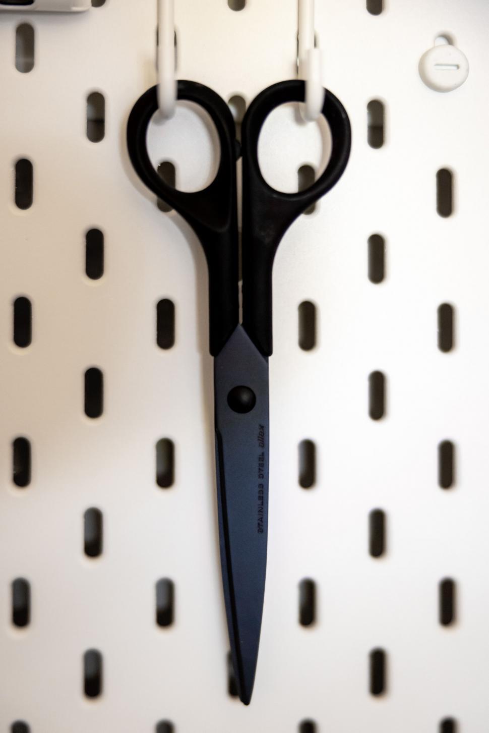 Free Image of Scissors hanging on a pegboard in a workshop 
