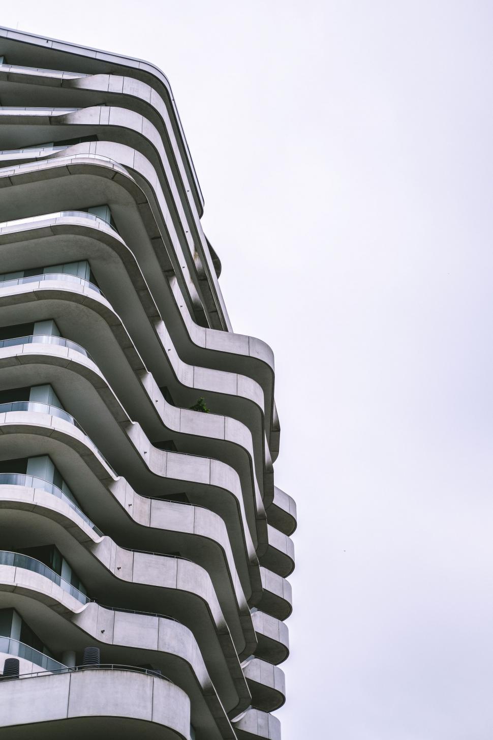 Free Image of Modern apartment building with wavy balconies 