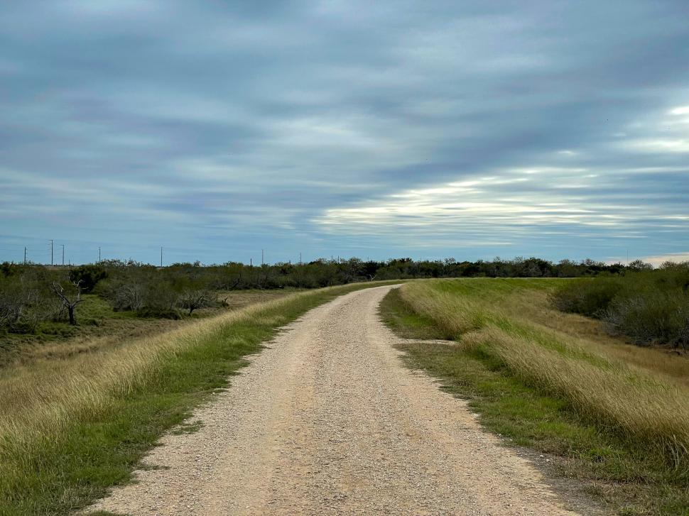 Free Image of Curving gravel road in open countryside 