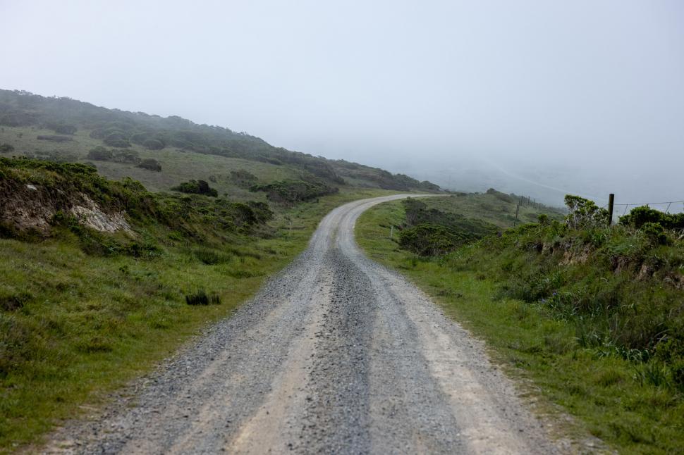 Free Image of Misty countryside road disappearing into fog 