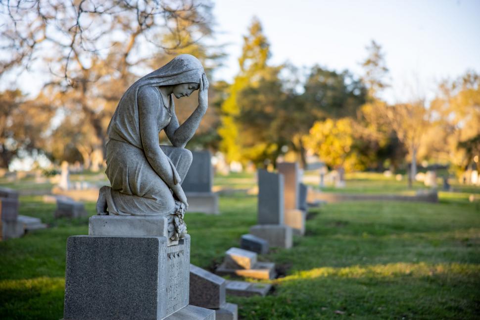 Free Image of Statue of a mourning figure at a cemetery 