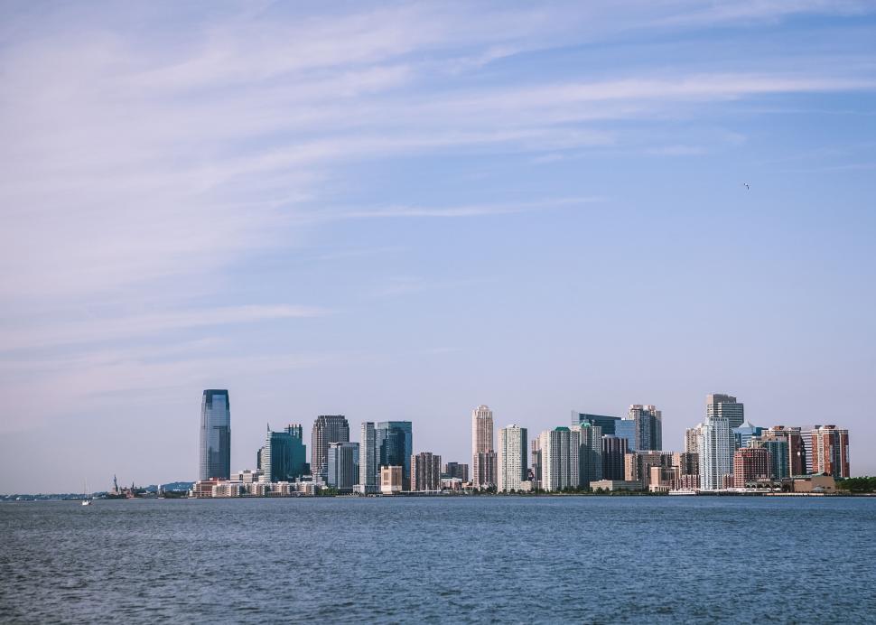Free Image of Serene waterfront view of city buildings 