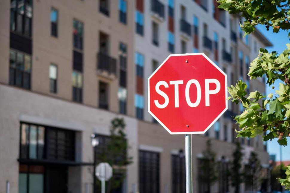 Free Image of Red stop sign against an urban backdrop 