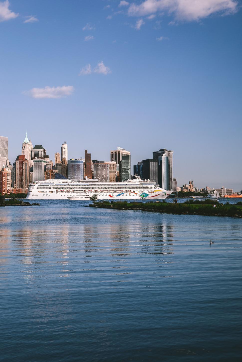 Free Image of City skyline with a cruise ship docked 