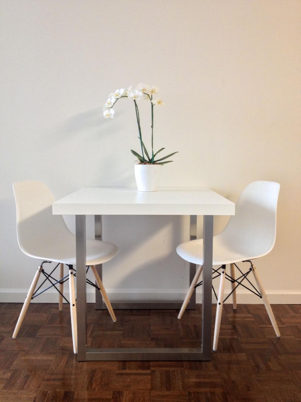 Free Image of Minimalist white dining table with chairs 