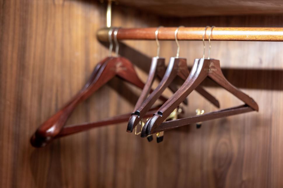Free Image of Wooden clothes hangers in a closet 