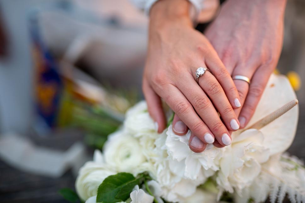 Free Image of Bridal hands showing ring and bouquet 