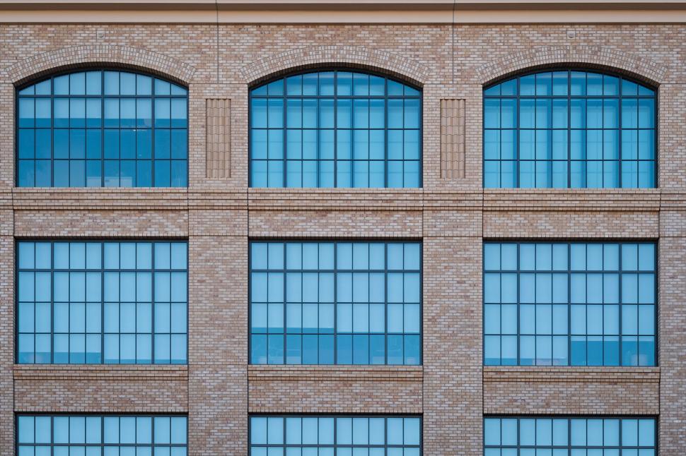Free Image of Symmetrical windows on a brick building facade 