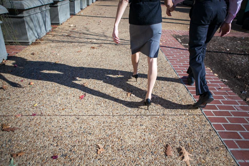 Free Image of Business professionals walking, casting shadows 