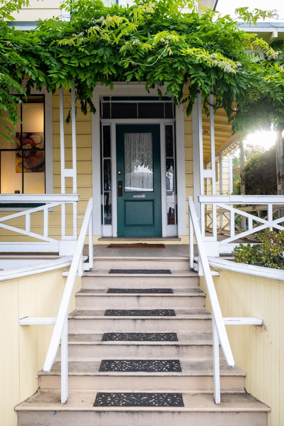 Free Image of Quaint house with a greenery-framed front door 