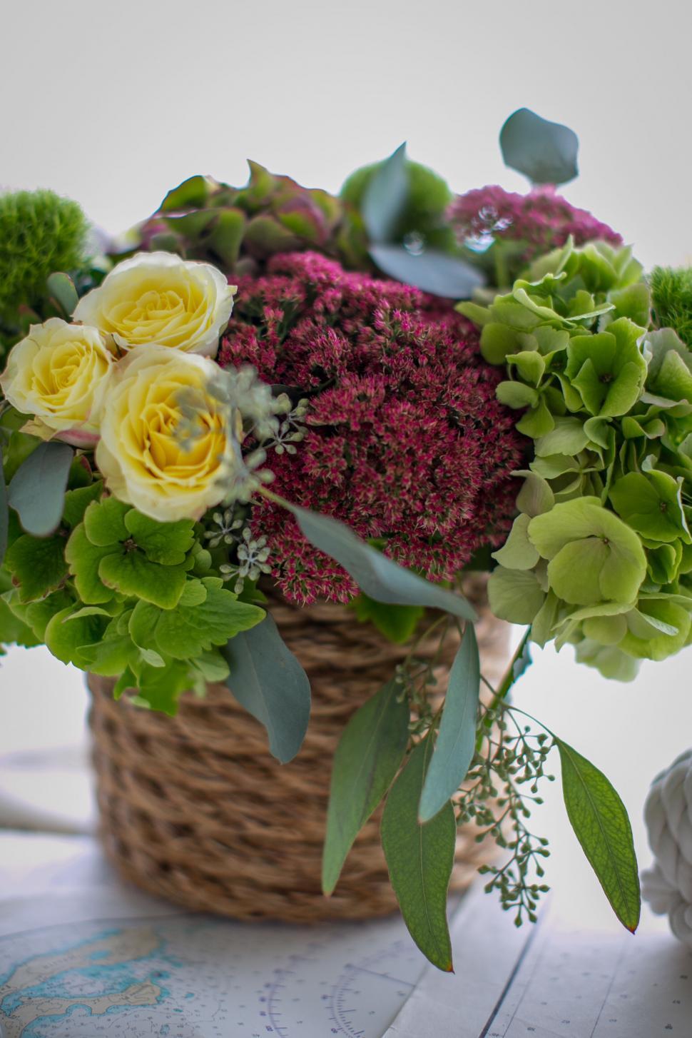 Free Image of Bouquet of flowers in a wicker basket centerpiece 
