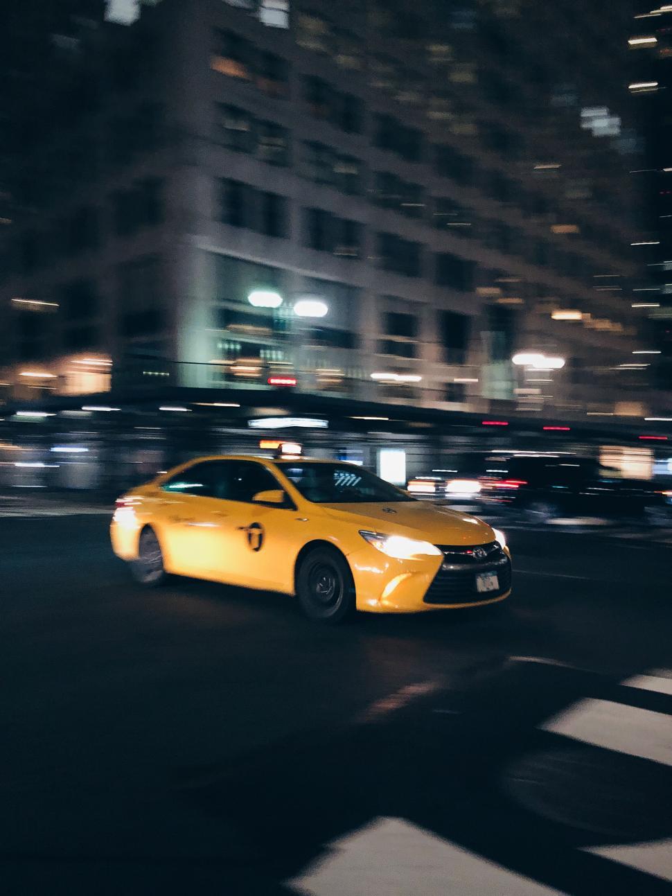 Free Image of Yellow taxi in motion on New York streets 