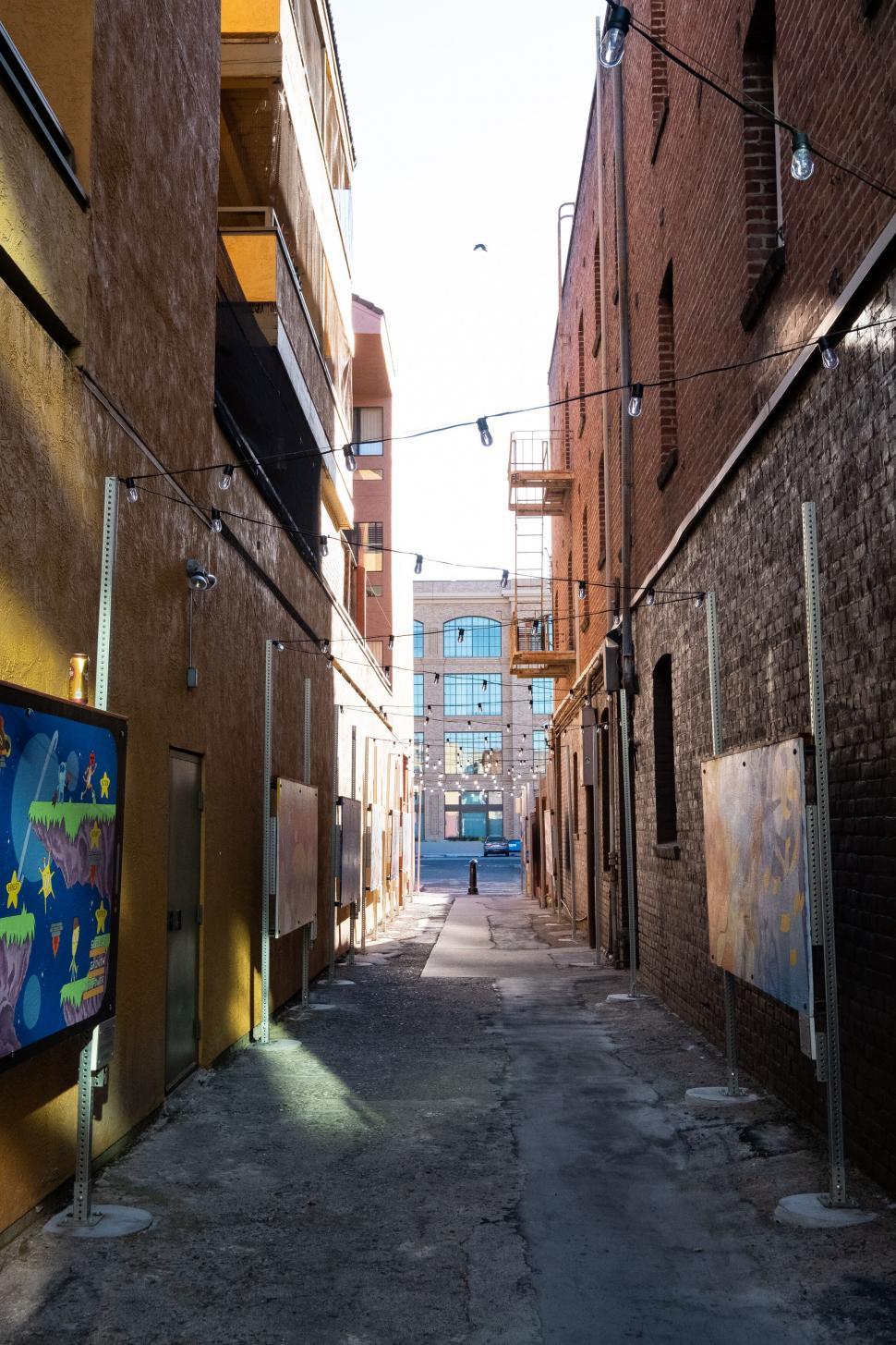 Free Image of Alleyway between brick buildings 