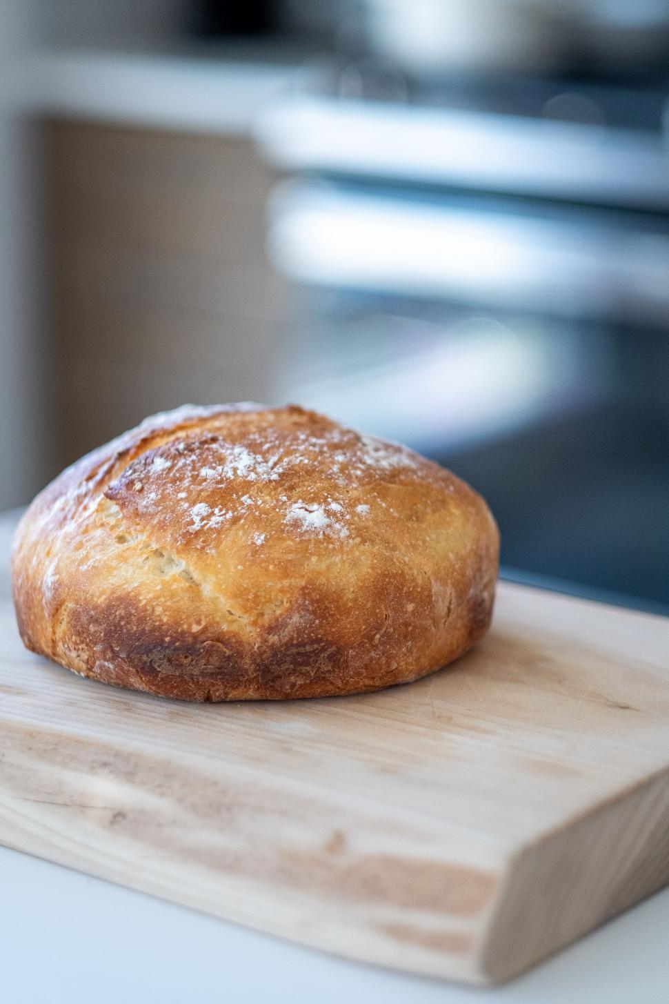 Free Image of Freshly baked artisan bread on a cutting board 