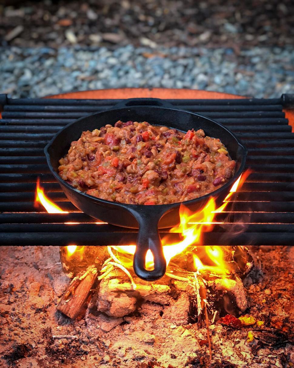 Free Image of Campfire cooking with a cast iron skillet 