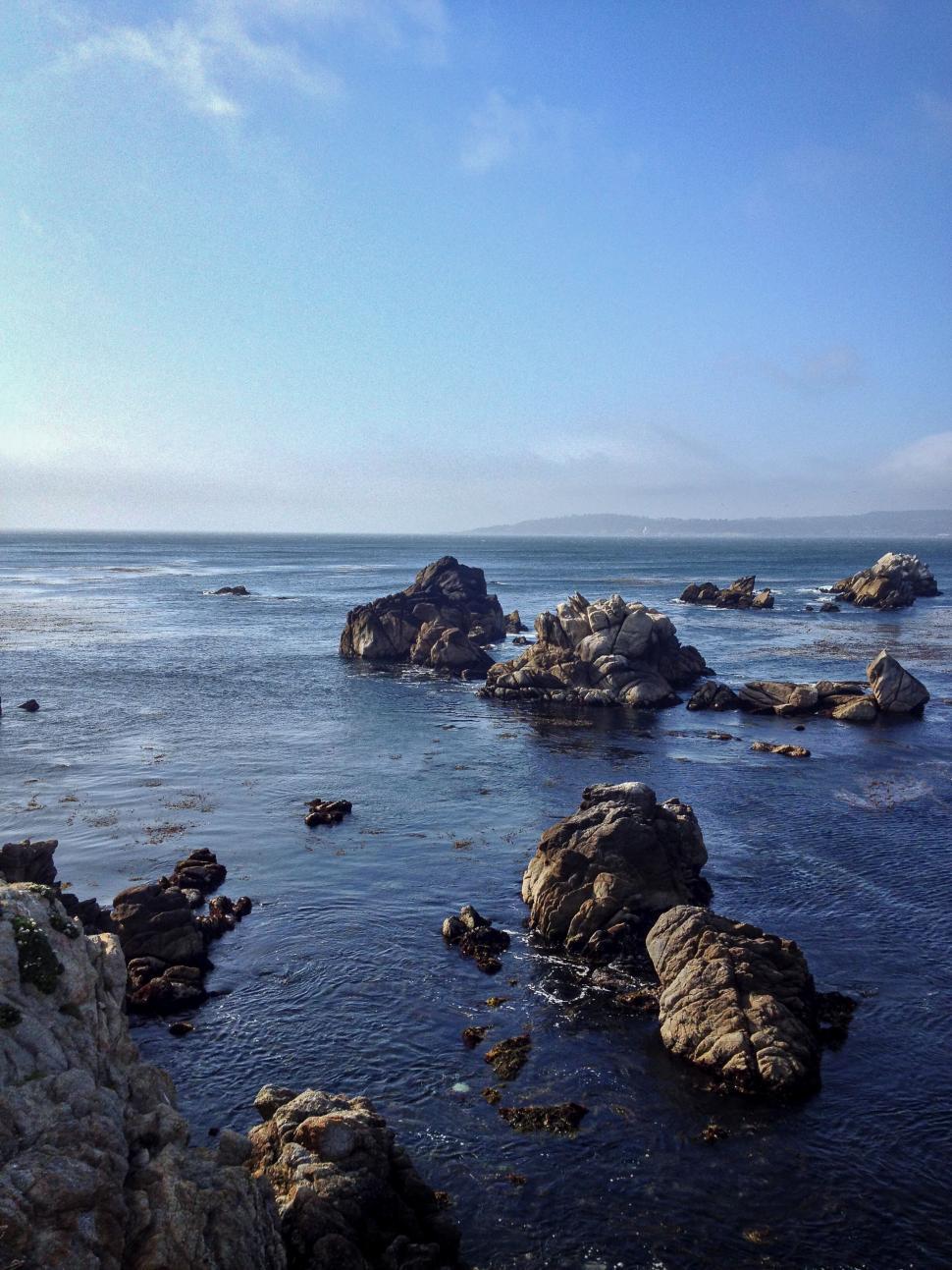 Free Image of Rocky coastal scene with blue ocean waters 