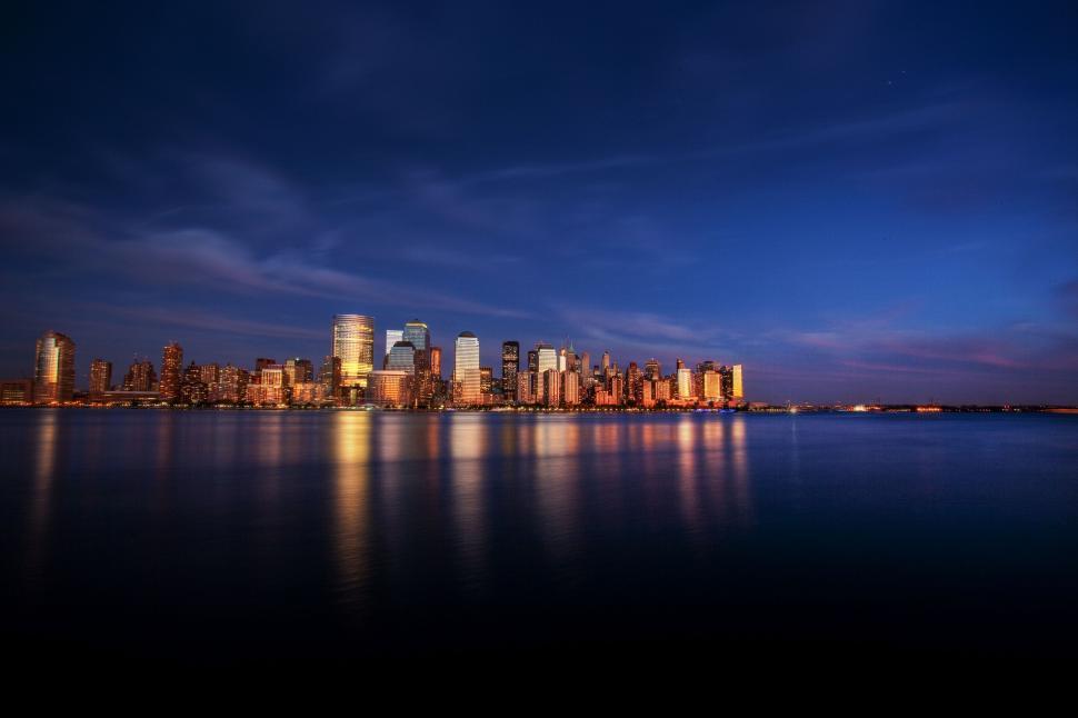 Free Image of Twilight city skyline reflection over water 