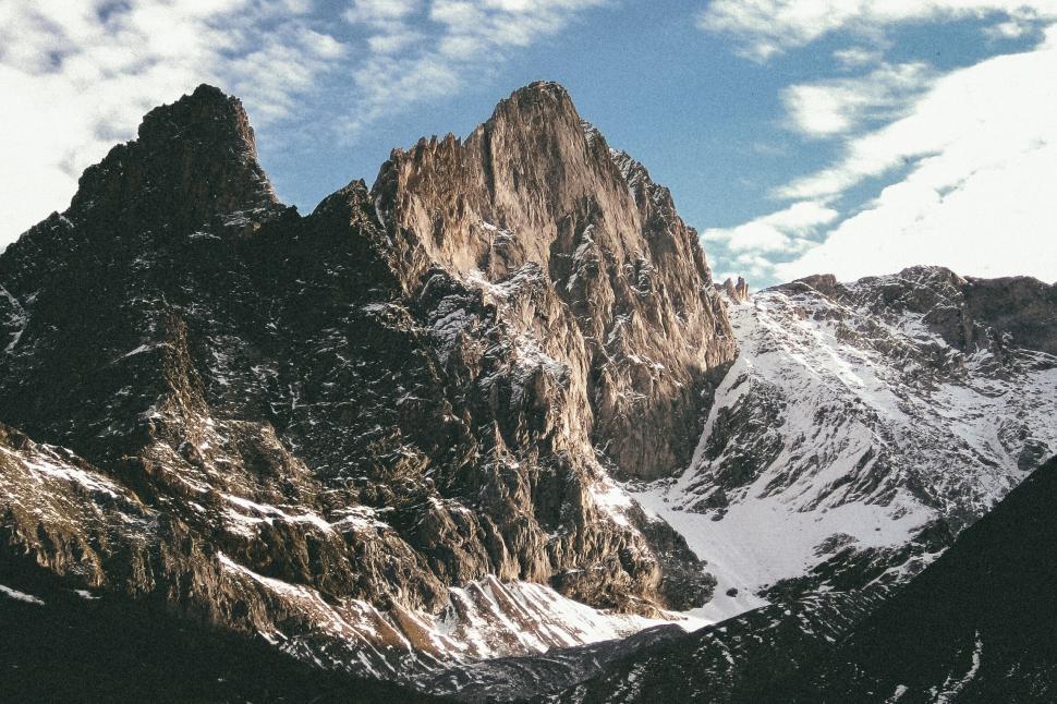 Free Image of Rugged mountain peak with snow patches 