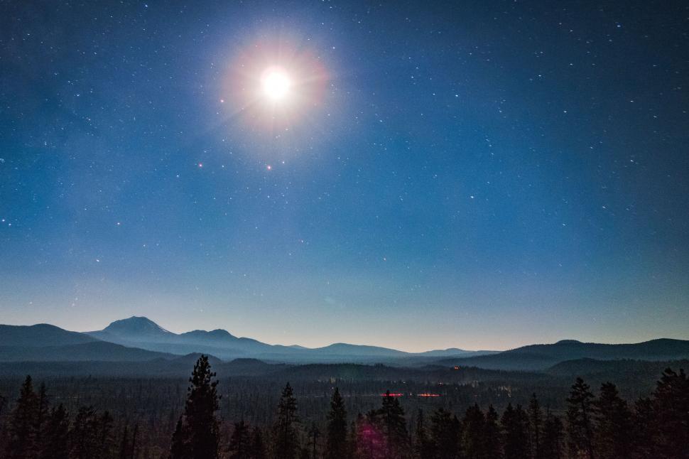 Free Image of Starry night over forest and mountains 