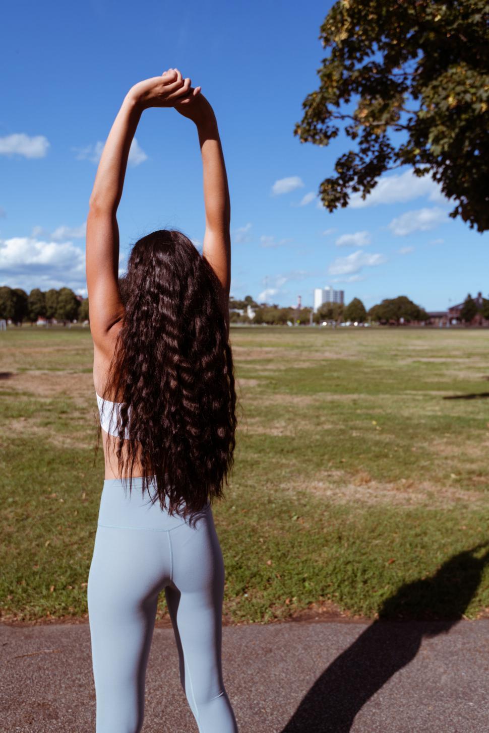 Free Image of Woman stretching exercising in a park 