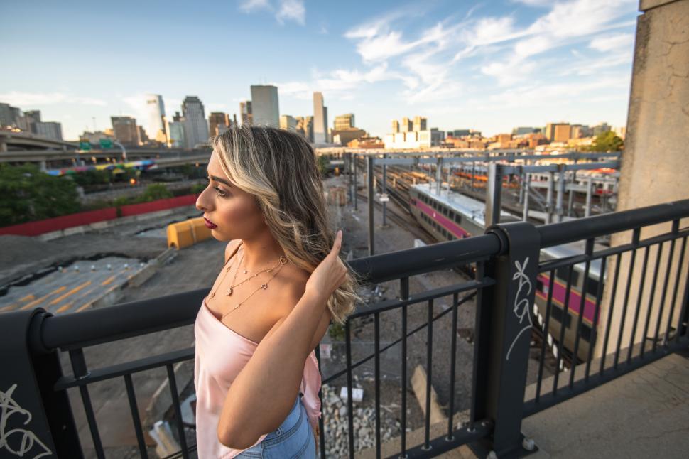 Free Image of Woman overlooking cityscape back turned 