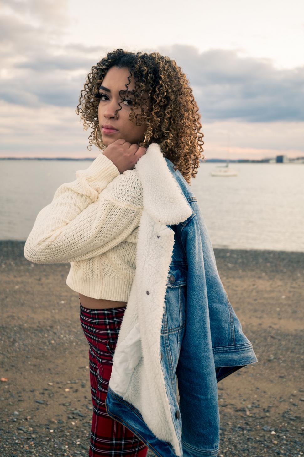 Free Image of Curly-haired woman by the sea 