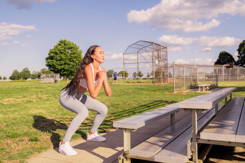 Free Image of Woman doing squats at a park 