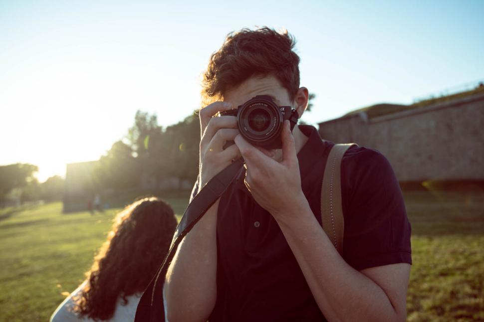 Free Image of Photographer capturing a moment during golden hour 