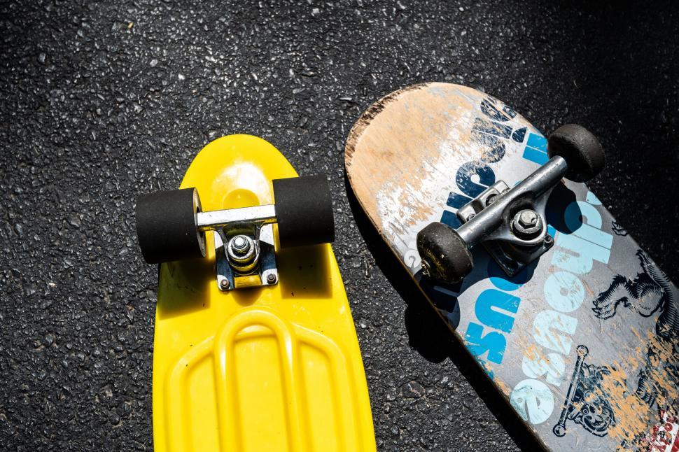Free Image of Two colorful skateboards on rough asphalt 