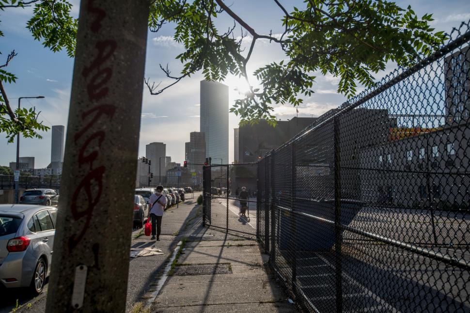 Free Image of Urban cityscape with fenced walkway and graffiti 