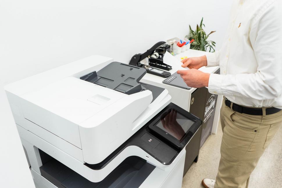 Free Image of Male office worker at modern multifunction printer 