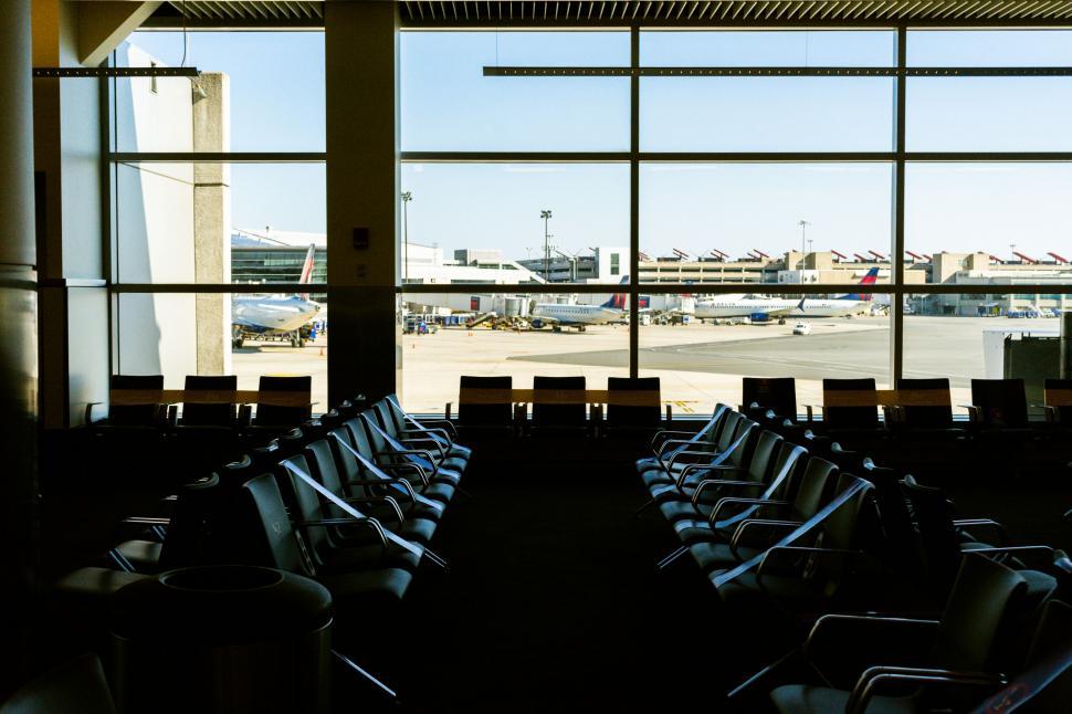 Free Image of Airport terminal with empty seats and planes 