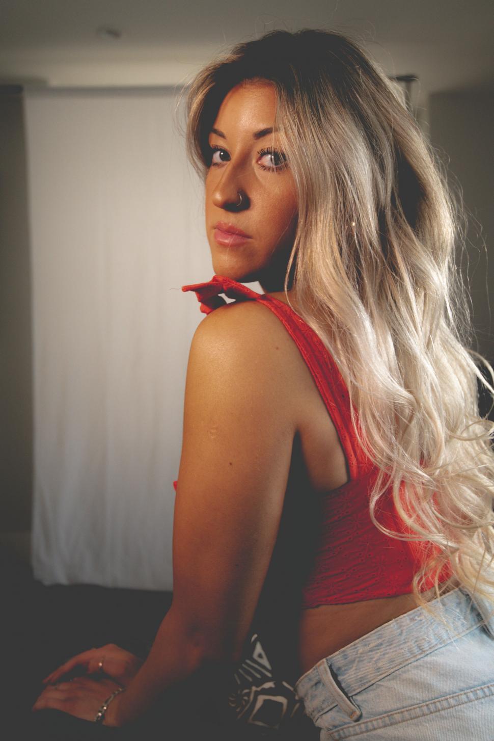 Free Image of Softly lit woman in a red top portrait 