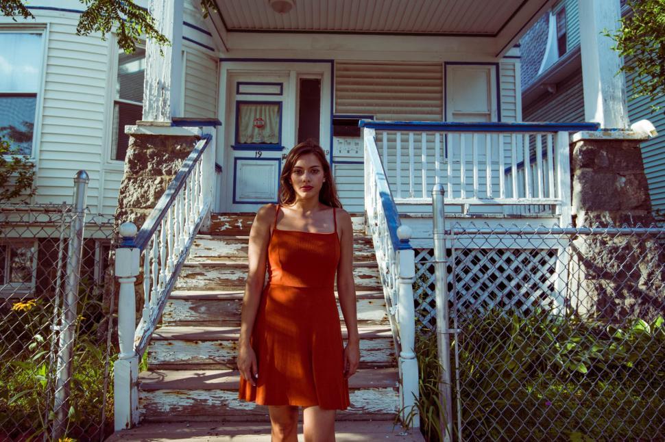 Free Image of Woman standing in front of house 